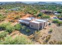 Aerial view of stucco home with flat roof, covered patio, and desert landscaping at 44811 N 12Th St, New River, AZ 85087