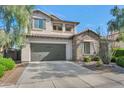 Two-story house with stone accents, a large garage, and mature landscaping at 3730 E Cat Balue Dr, Phoenix, AZ 85050
