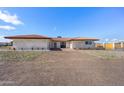 White brick home with a red tile roof, double doors, and a gravel driveway at 14700 S Tuthill Rd, Buckeye, AZ 85326
