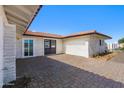 Front view of the home showcasing the brick facade and entrance at 14700 S Tuthill Rd, Buckeye, AZ 85326
