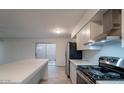 Modern kitchen with white cabinets, quartz countertops, and stainless steel appliances at 2625 E 10Th St, Tempe, AZ 85288
