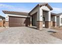 New construction home with a brown garage door and a paved driveway at 682 E Aurora Dr, San Tan Valley, AZ 85140