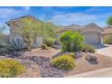 Single-story home with two-car garage and drought-tolerant landscaping at 5221 E Thunder Hawk Rd, Cave Creek, AZ 85331