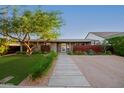 Mid-century modern home with lawn and landscaping at 4135 E Glenrosa Ave, Phoenix, AZ 85018