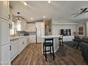 Modern kitchen with white cabinets, quartz countertops, and wood-look flooring at 650 N Hawes Rd # 4409, Mesa, AZ 85207