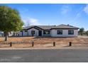 Single-story home with a white exterior and brown roof at 19609 E Starflower Dr, Queen Creek, AZ 85142