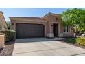 Beautiful one-story home with a two-car garage and landscaped yard at 12957 W Hummingbird Ter, Peoria, AZ 85383