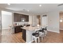 Modern kitchen featuring dark cabinetry, granite island, and a walk-in pantry at 269 S 190Th Dr, Buckeye, AZ 85326