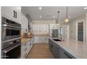 Modern kitchen with white cabinets, stainless steel appliances, and a large island with granite countertops at 29811 N 154Th St, Scottsdale, AZ 85262