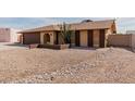 Front view of the house with a gravel driveway and landscaping at 3837 W Dailey St, Phoenix, AZ 85053