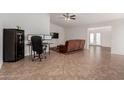 Living room with tile flooring, brown couch, and home office at 3837 W Dailey St, Phoenix, AZ 85053