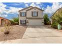 Two story home with beige exterior, brown shutters, and a two car garage at 42999 W Samuel Dr, Maricopa, AZ 85138