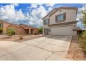 Two story home with beige exterior, brown shutters, and a two car garage at 42999 W Samuel Dr, Maricopa, AZ 85138