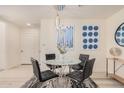 Modern dining area with glass table and four black chairs at 7300 E Earll Dr # 2021, Scottsdale, AZ 85251