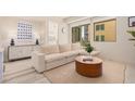 Bright living room featuring a sectional sofa and large window at 7300 E Earll Dr # 2021, Scottsdale, AZ 85251