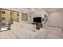 Living room with sectional sofa and access to a balcony at 7300 E Earll Dr # 2021, Scottsdale, AZ 85251
