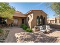 Inviting front entry with a wooden door and seating area at 36482 N Boulder View Dr, Scottsdale, AZ 85262