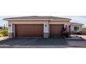 Two-car garage with stone accents and landscaping at 33632 N Rifleman Rd, Cave Creek, AZ 85331