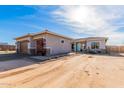 Tan two-story house with teal door and two-car garage at 33632 N Rifleman Rd, Cave Creek, AZ 85331