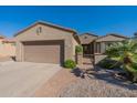 Single-story home with a two-car garage and desert landscaping at 20340 N Canyon Whisper Dr, Surprise, AZ 85387