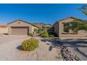 Single story home with a two-car garage and well maintained landscaping at 20340 N Canyon Whisper Dr, Surprise, AZ 85387