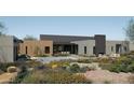 Luxury backyard oasis featuring a modern pool and desert landscaping at 10610 E Stoney Cir, Scottsdale, AZ 85262