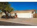 House exterior showcasing a white garage door and mature tree at 4832 E Western Star Blvd, Phoenix, AZ 85044