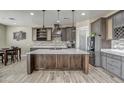 Modern kitchen with large island, stainless steel appliances, and ample cabinetry at 29923 W Melvin St, Buckeye, AZ 85396