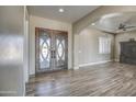 Elegant entryway with double doors and wood-look tile flooring at 29923 W Melvin St, Buckeye, AZ 85396