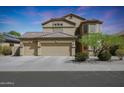 Two-story house with three-car garage and desert landscaping at 18516 W Sweet Acacia Dr, Goodyear, AZ 85338