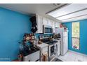 Bright kitchen with white cabinets and blue walls at 3119 W Cochise Dr # 245, Phoenix, AZ 85051