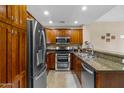 Modern kitchen with stainless steel appliances and wood cabinets at 5450 E Deer Valley Dr # 3004, Phoenix, AZ 85054