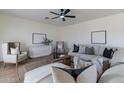 Spacious living room with L-shaped sectional sofa and modern decor at 23045 W Hopi St, Buckeye, AZ 85326