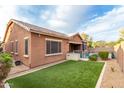 Private backyard oasis with a sparkling pool, lush grass, and a covered patio at 2247 E Indian Wells Dr, Gilbert, AZ 85298