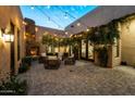 Charming outdoor patio with string lights and fireplace at 8742 E Villa Cassandra Dr, Scottsdale, AZ 85266