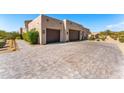 Three-car garage with paver driveway at 8742 E Villa Cassandra Dr, Scottsdale, AZ 85266