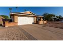 Ranch style home with a two car garage and mature landscaping at 2705 W Summit Pl, Chandler, AZ 85224