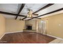 Living room features hardwood floors, a brick fireplace, and wood beam ceilings at 5850 W Cheery Lynn Rd, Phoenix, AZ 85031