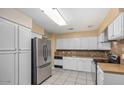 Kitchen with white cabinets, stainless steel appliances, and tile flooring at 5850 W Cheery Lynn Rd, Phoenix, AZ 85031