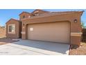 Tan two-car garage home with desert landscaping at 727 W Judi Dr, Casa Grande, AZ 85122