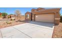 Tan one story home with a two-car garage and desert landscaping at 727 W Judi Dr, Casa Grande, AZ 85122