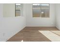Spacious dining area with large windows and wood-look tile floors at 16173 S 181St Ave, Goodyear, AZ 85338