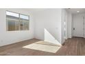 Bright entryway with wood-look tile flooring and neutral walls at 16173 S 181St Ave, Goodyear, AZ 85338