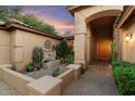 Private courtyard with fountain, plants, and entrance to the home at 6969 E Bobwhite Way, Scottsdale, AZ 85266