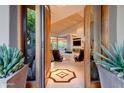 Elegant entryway with wood doors opening to a spacious living area at 39032 N 101St Way, Scottsdale, AZ 85262