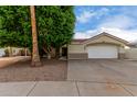 House exterior with a garage and landscaping at 1114 N Velma Ct, Gilbert, AZ 85233