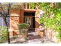 Inviting entryway to a stunning property with mature landscaping and unique architectural details at 15972 N 115Th Way, Scottsdale, AZ 85255