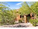 Beautiful desert landscape surrounds this home with a charming exterior at 15972 N 115Th Way, Scottsdale, AZ 85255