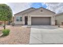 One-story house with a brown garage door and a small front yard at 17078 N Rosemont St, Maricopa, AZ 85138