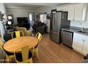 Open kitchen with stainless steel appliances and yellow table set at 4065 E University Dr # 300, Mesa, AZ 85205